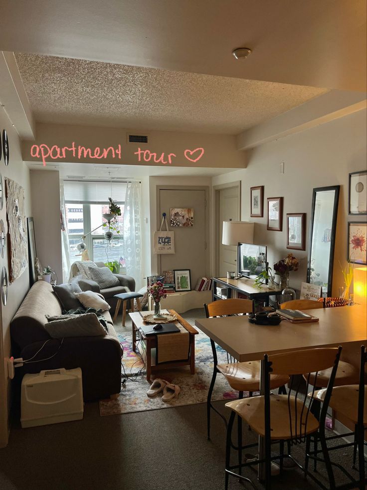 a living room filled with lots of furniture and pictures on the wall next to a window