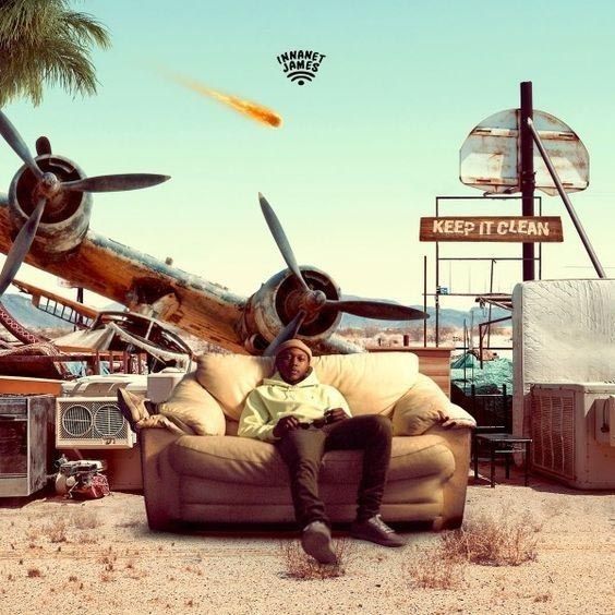 a man sitting on top of a couch in front of an old airplane and junkyard