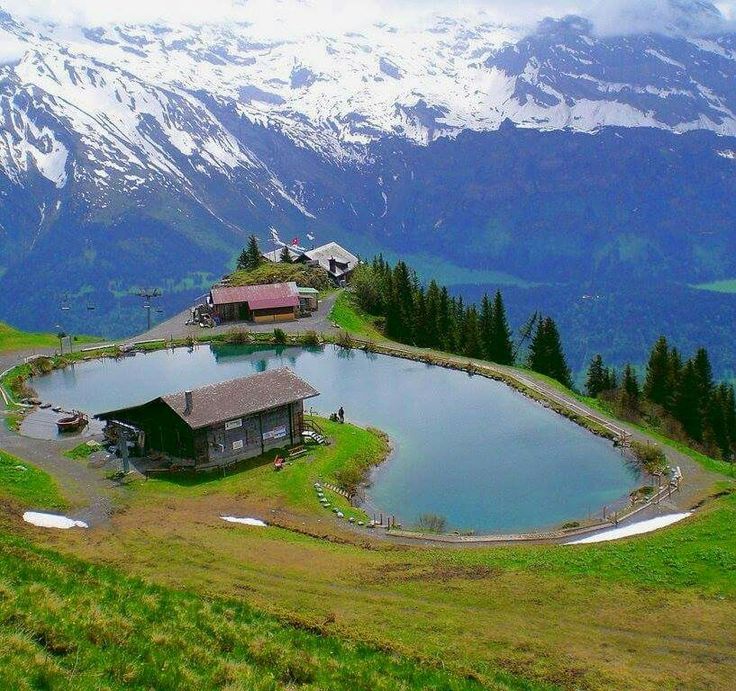 an aerial view of a small lake surrounded by mountains