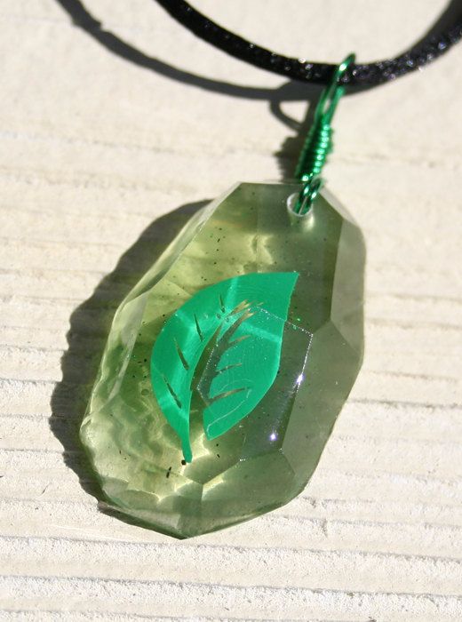 a green necklace with a leaf on it