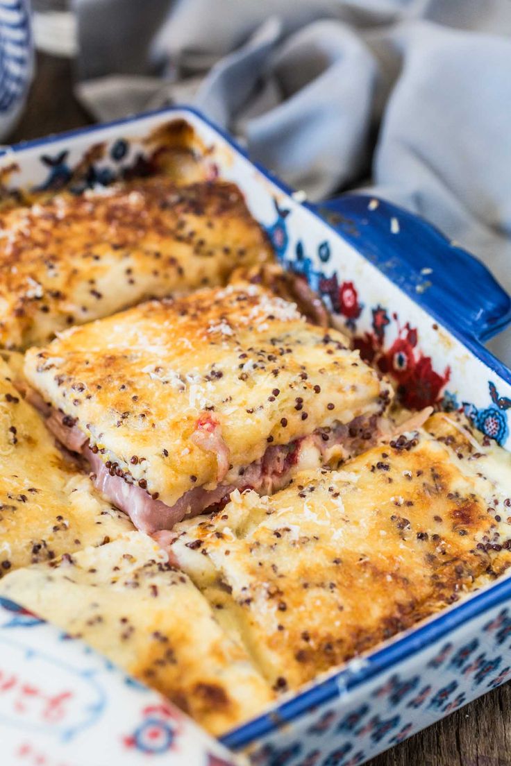 a casserole dish with meat and cheese in it sitting on a table top