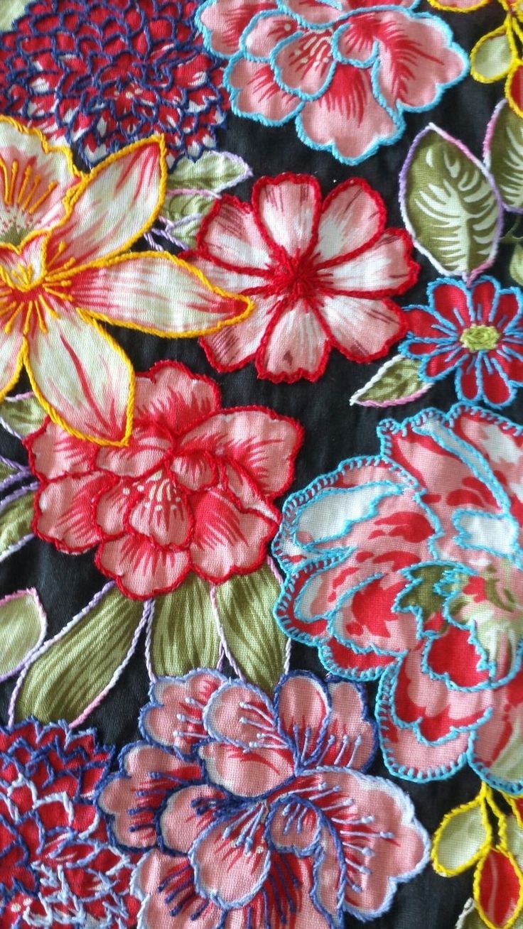 an embroidered fabric with flowers and leaves on it