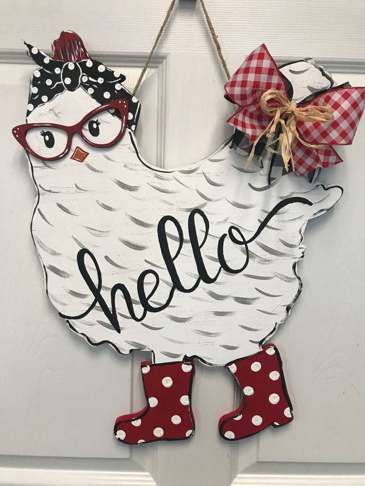 a door hanger with a chicken wearing red and white polka dot boots on it