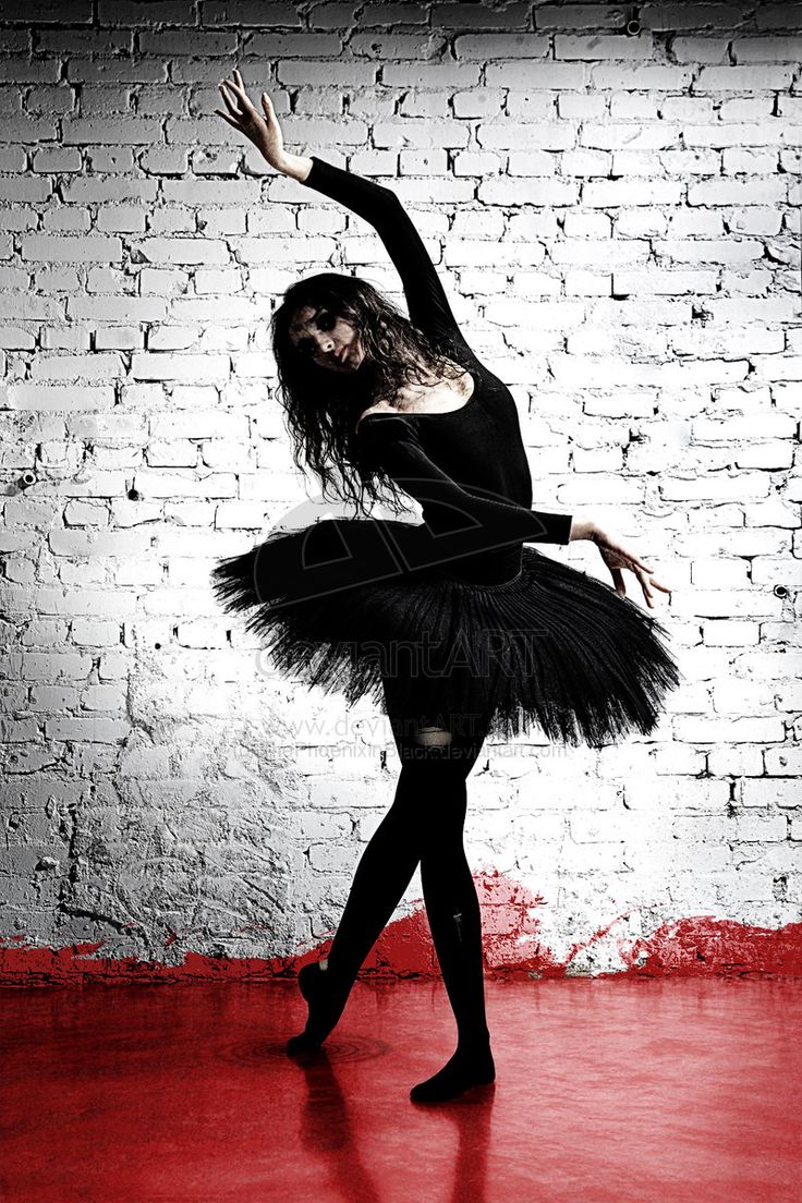 a ballerina in black and white is posing for the camera