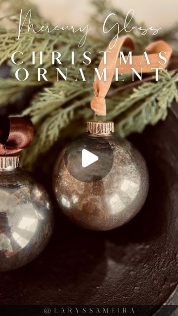 two ornaments sitting on top of a wooden bowl next to a pine branch with the words, thomas gleier's christmas ornaments ornaments