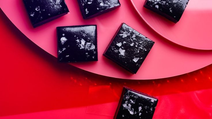 four pieces of chocolate on a pink plate