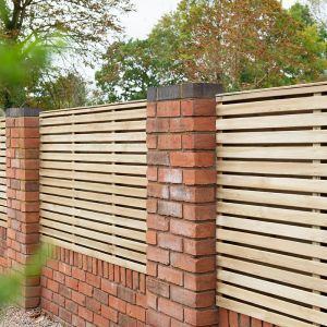 a brick wall with a wooden slatted fence on the top and bottom part