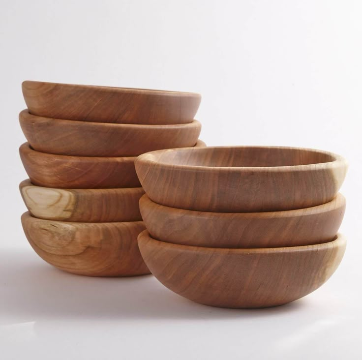 four wooden bowls stacked on top of each other