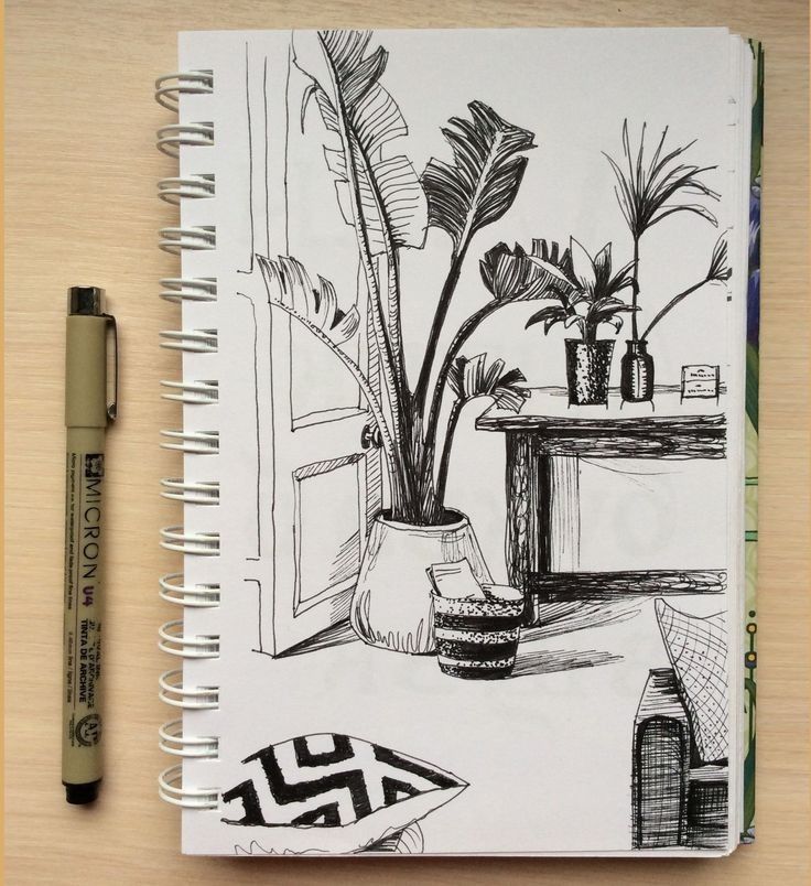 a drawing of a potted plant next to a desk with a pen on it