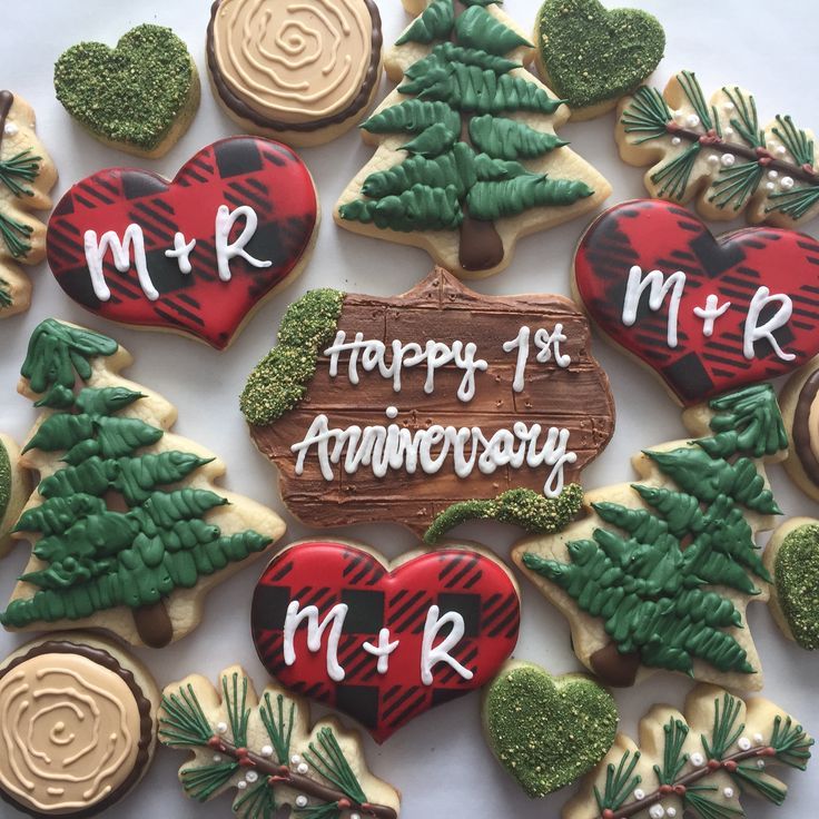 decorated cookies in the shape of christmas trees and hearts with words written on them that read mr and mrs happy 1st anniversary