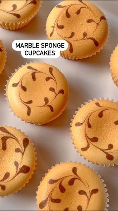 many cupcakes with faces drawn on them