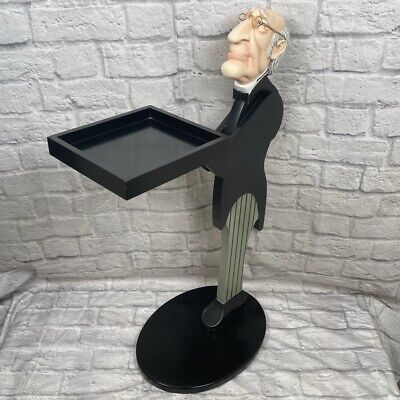 a sculpture of a man holding a tray with his head on it's back