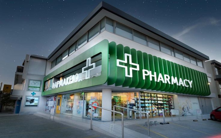 a pharmacy store is lit up at night