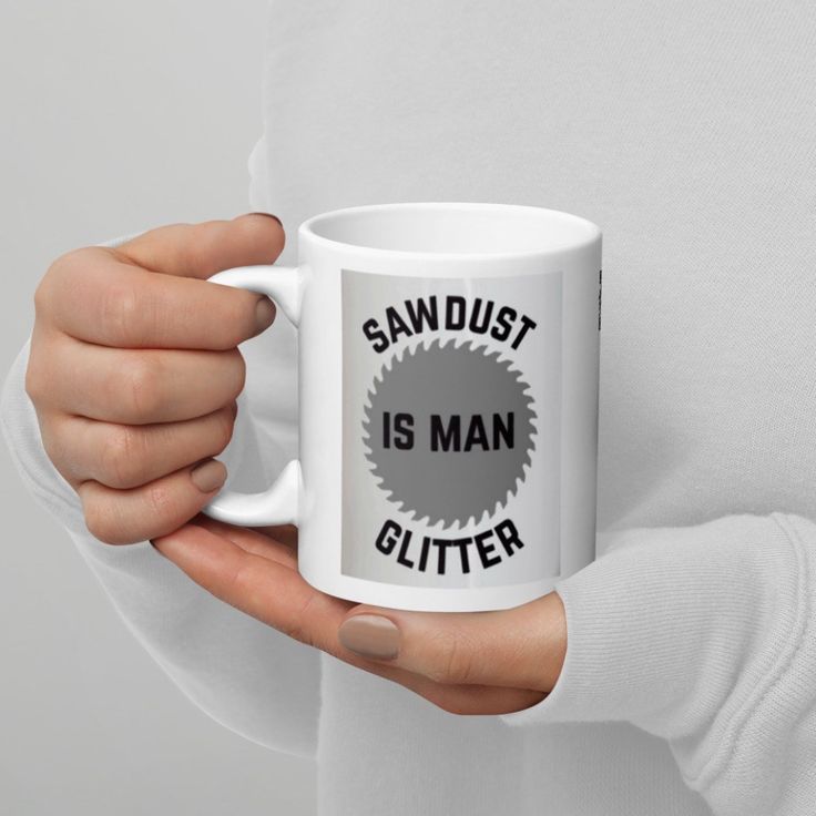 a person holding a coffee mug with sawdust is man glitter on it