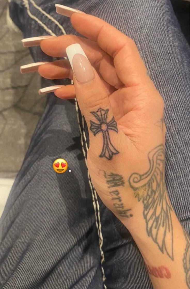 a woman's hand with tattoos on it