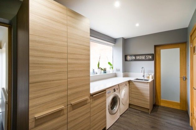 a washer and dryer are in the middle of this modern home laundry room