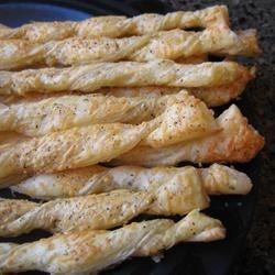 some chicken sticks are sitting on a black plate and ready to be cooked in the oven