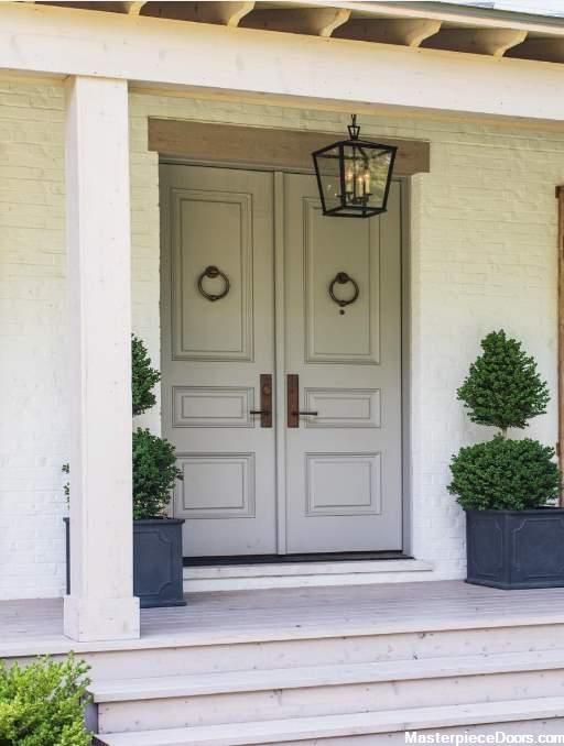 two planters on the front steps of a house