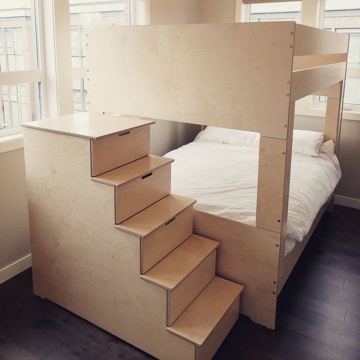 there is a bunk bed with stairs in the room