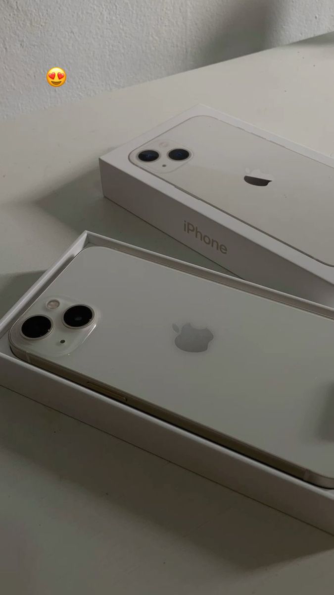 two new iphones are sitting on the table