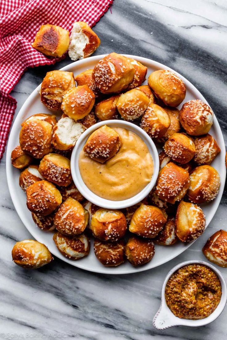 a white plate topped with croissants and dipping sauce