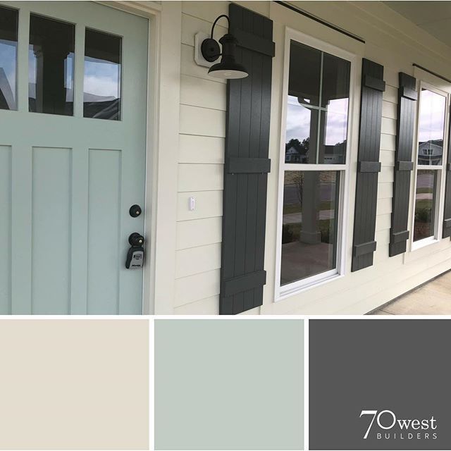 an exterior color scheme for a house with white siding and black shutters on the front door