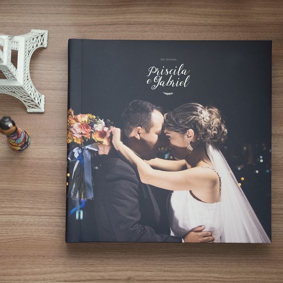 a wedding photo book on a wooden table