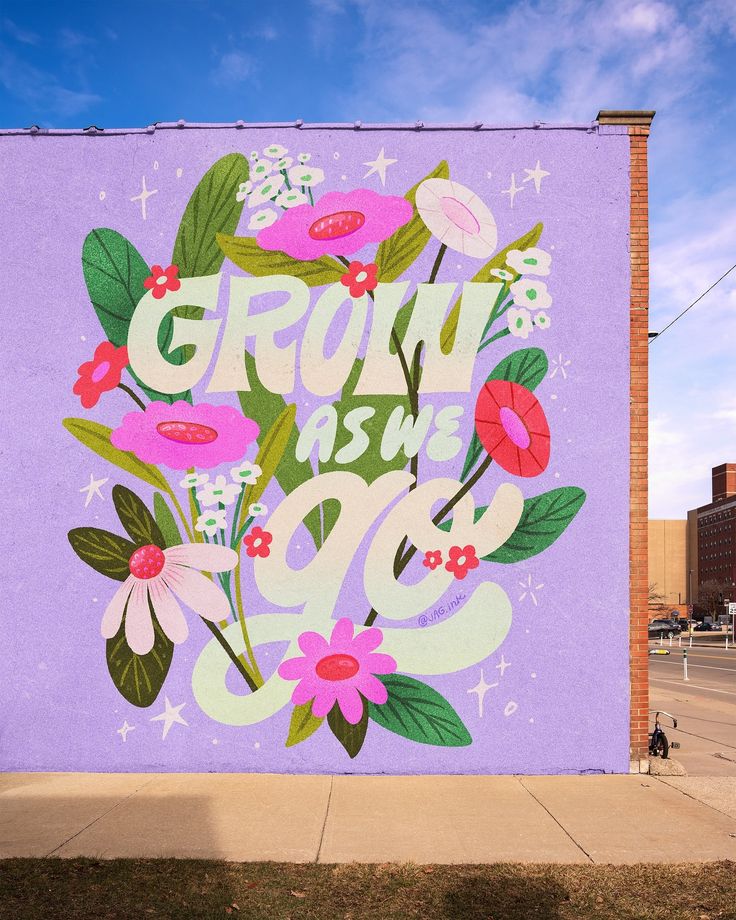 a large mural painted on the side of a building that says grow as you go