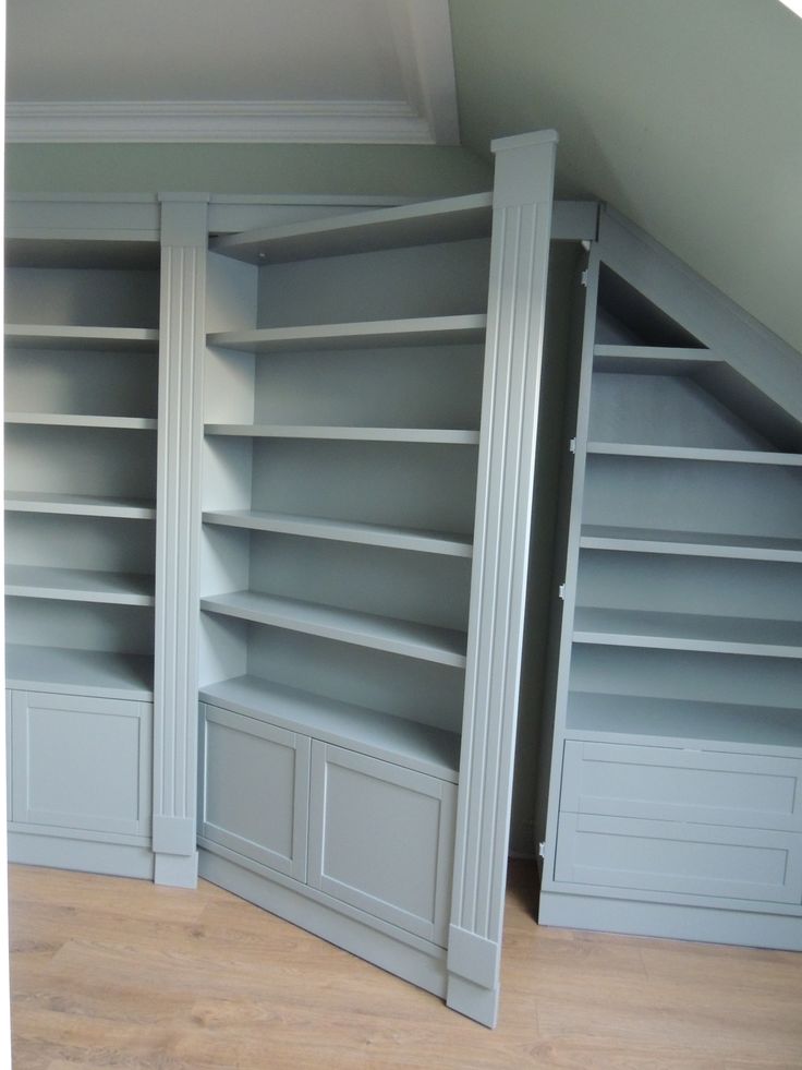 an empty bookcase in the corner of a room