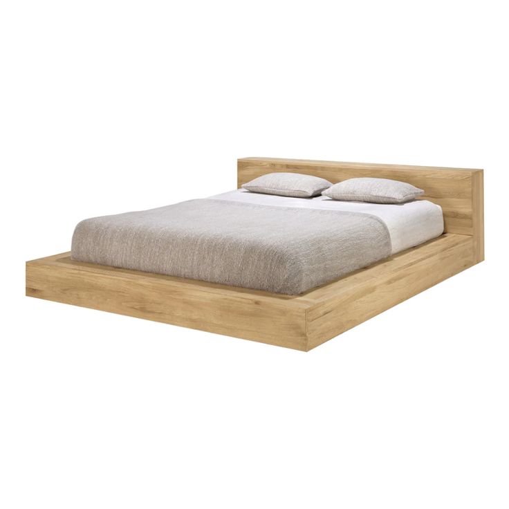 a bed that is made up and has two pillows on top of it, with the headboard turned down