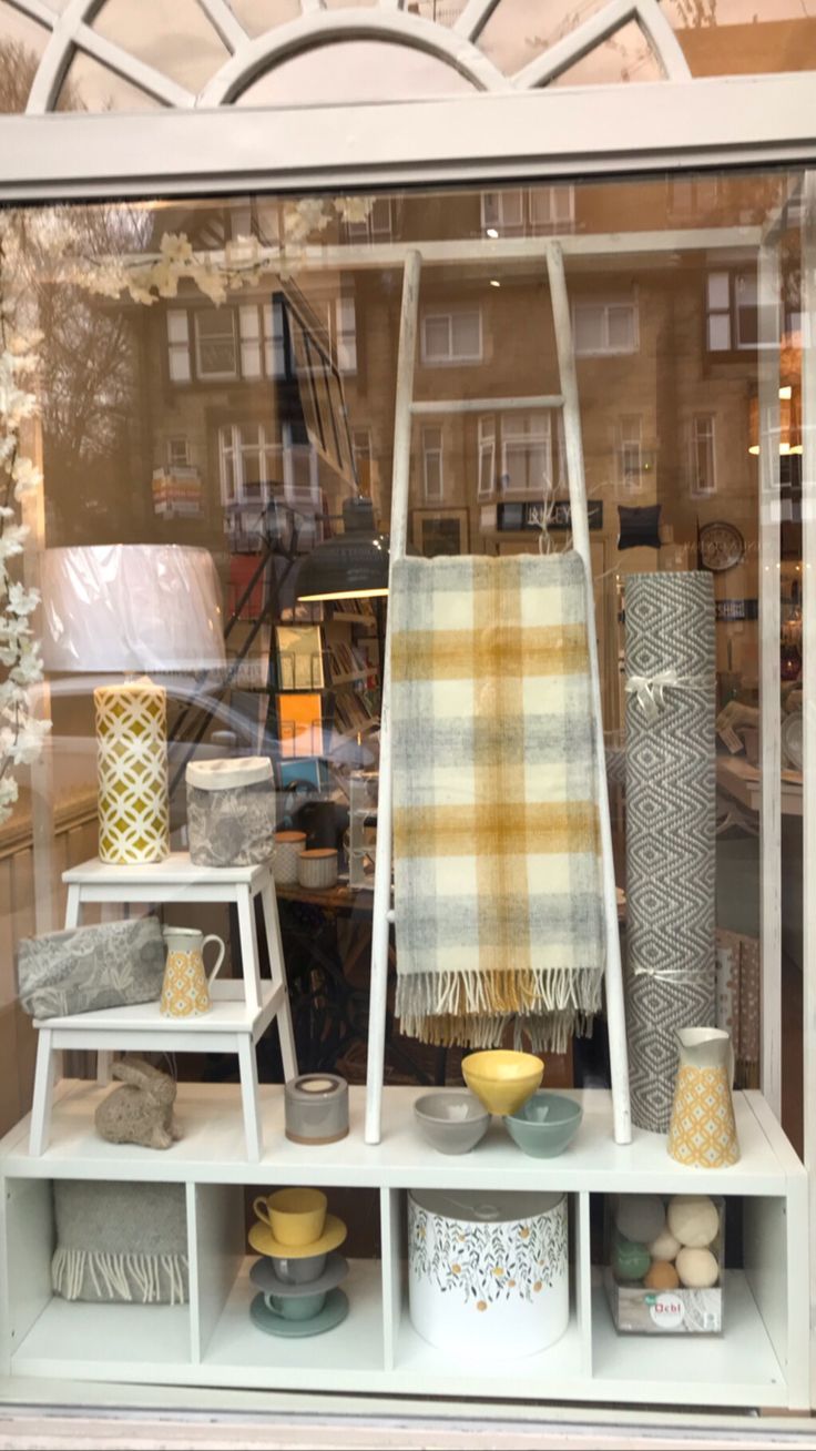 a display case with many different items in the front and behind it is a plaid blanket