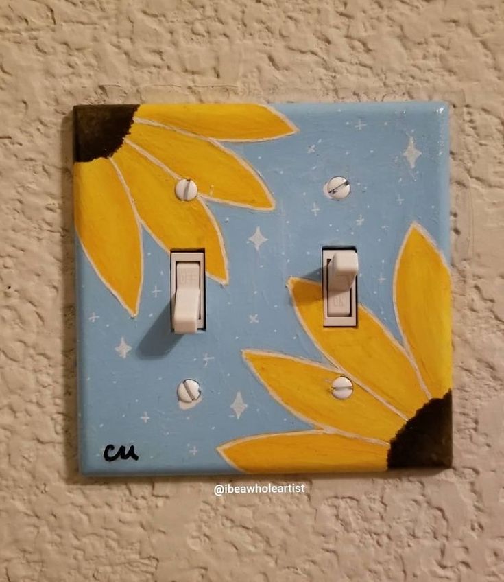 a light switch cover with sunflowers painted on it