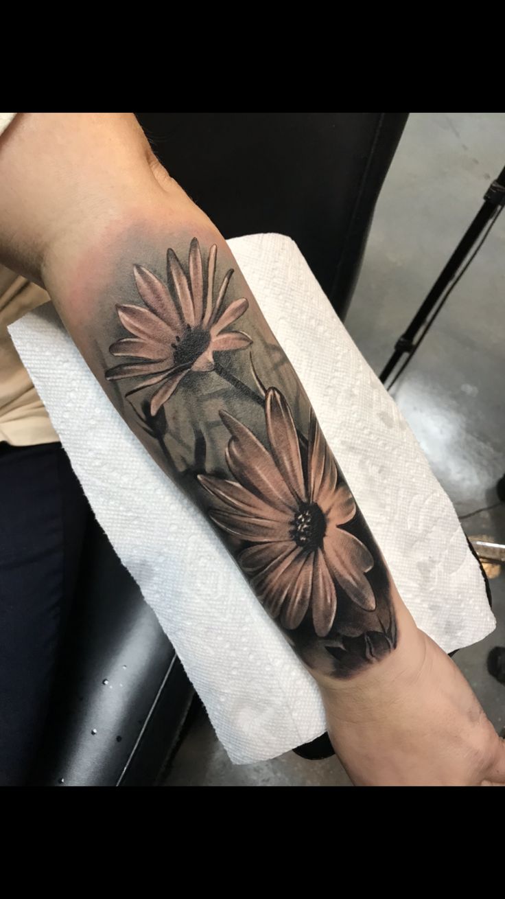 a person with a flower tattoo on their arm