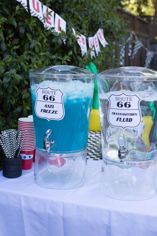 there are three glasses on the table with different drinks in front of them and one is blue