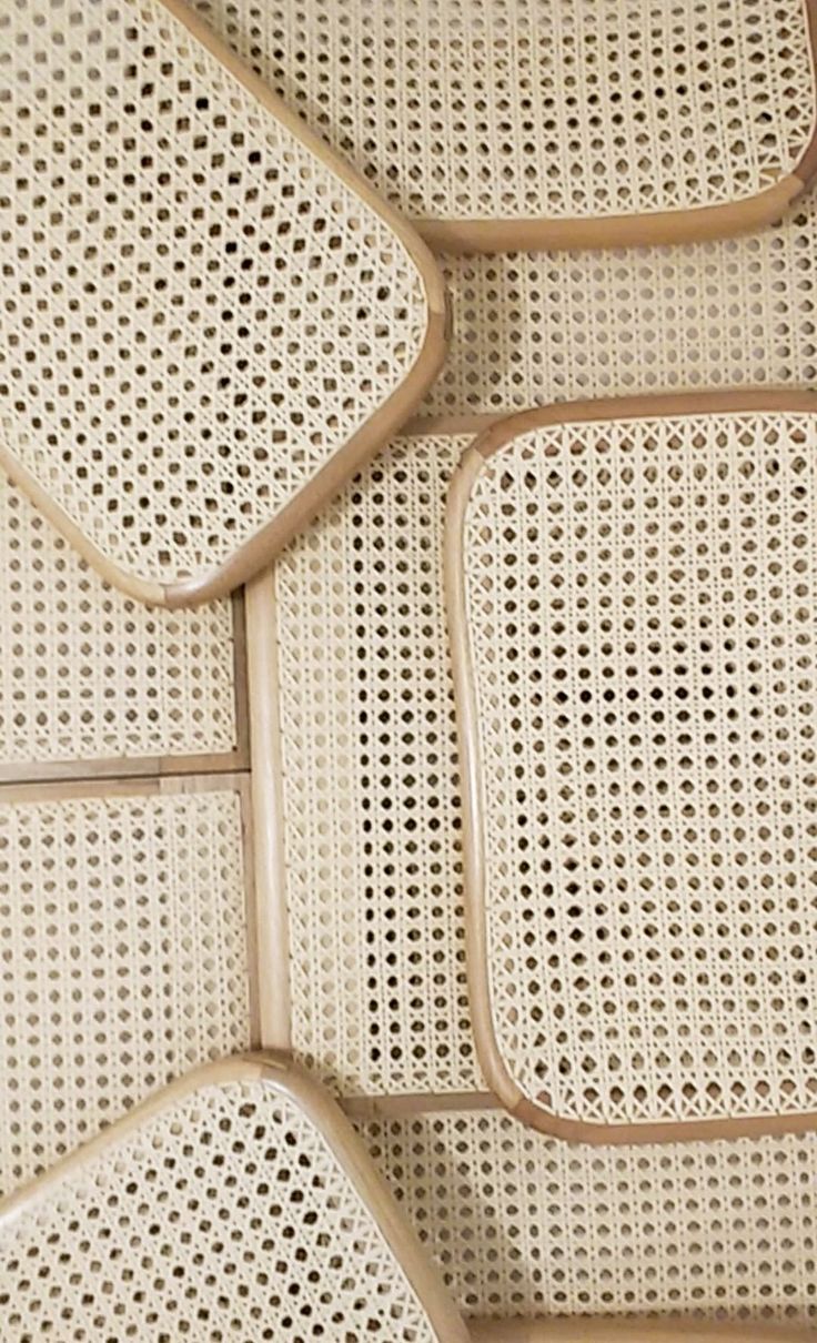 four white wicker placemats sitting on top of each other with holes in them