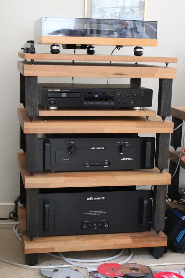 a stack of stereo equipment sitting on top of a wooden shelf