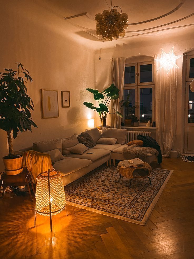 a living room filled with furniture next to a window covered in curtains and light bulbs