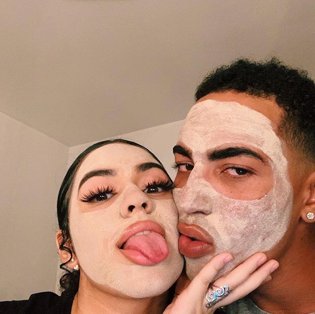 a man and woman with facial masks on their faces