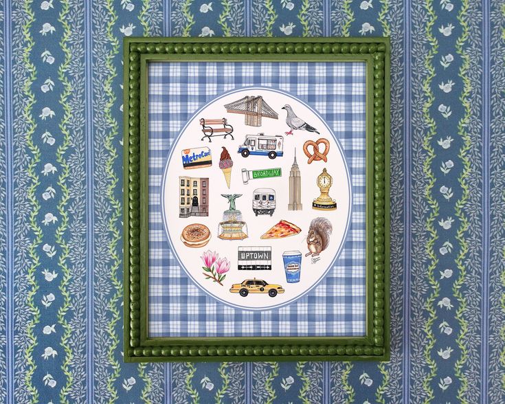 a cross stitch pattern in a green frame on a blue and white wallpapered background