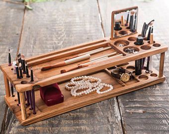 an assortment of makeup and make - up items on a wooden table