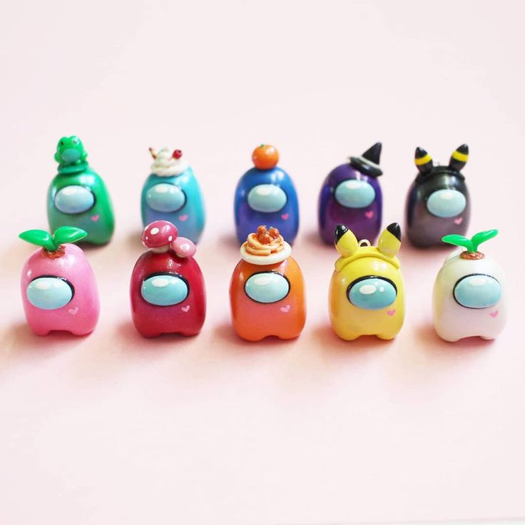 a group of small toy toys sitting on top of a white table next to each other