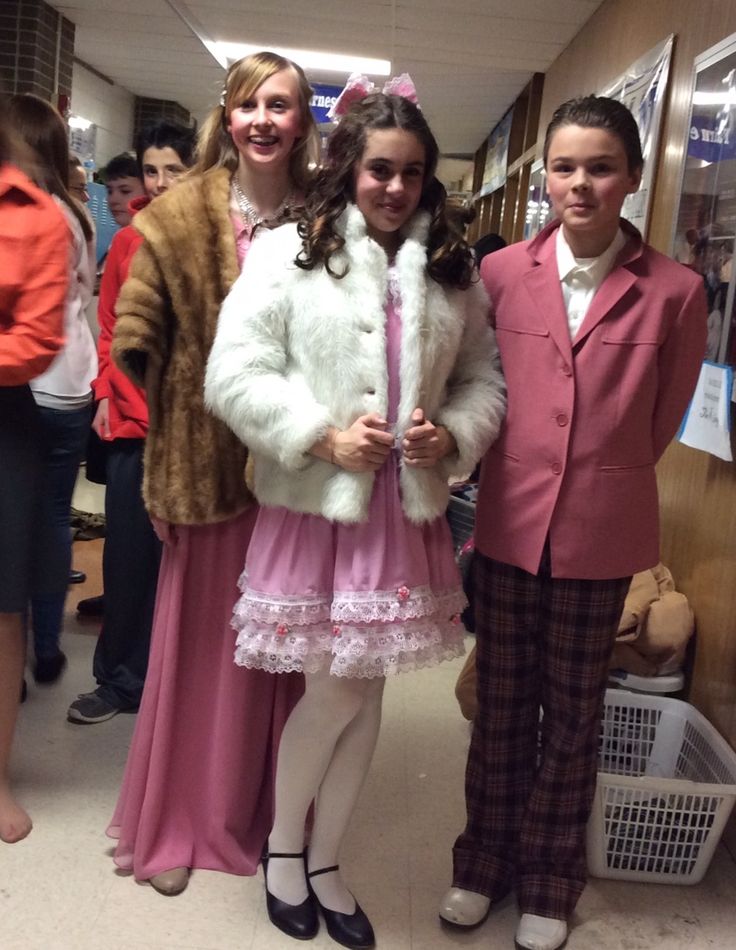 two girls and one boy are dressed up in costumes