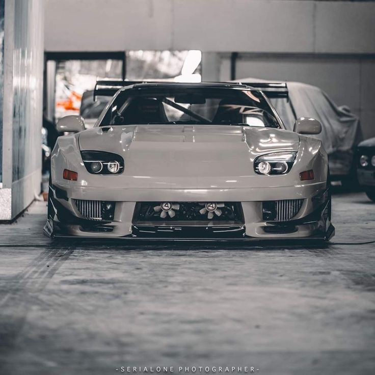 a white sports car parked in a garage