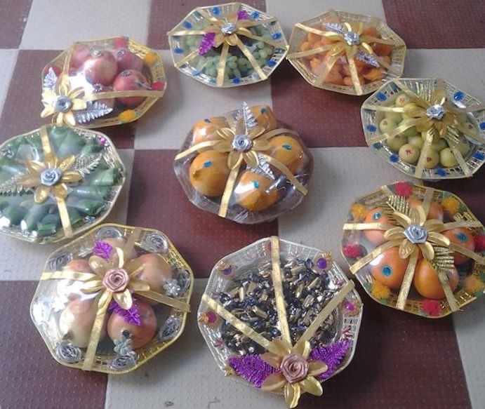 there are many different types of candies in glass bowls on the table together with ribbons tied around them