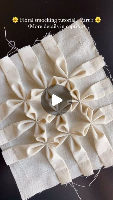 the video shows how to make a flower decoration with fabric and buttons on it's side