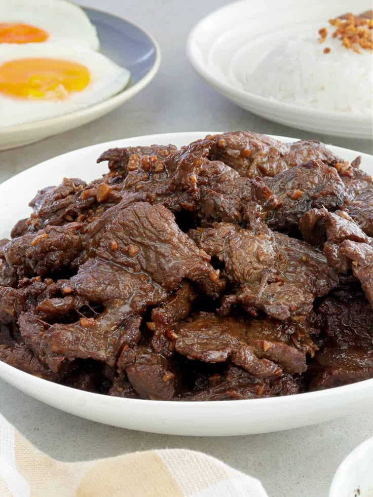 a white bowl filled with beef and eggs