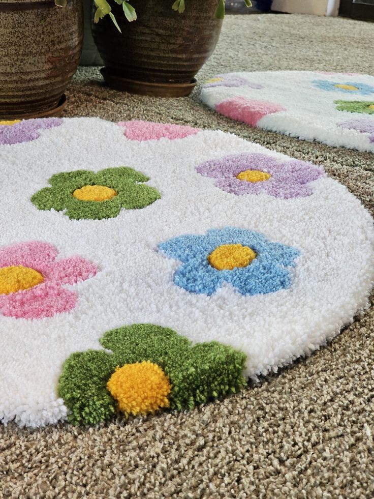 two potted plants sitting on top of a carpet