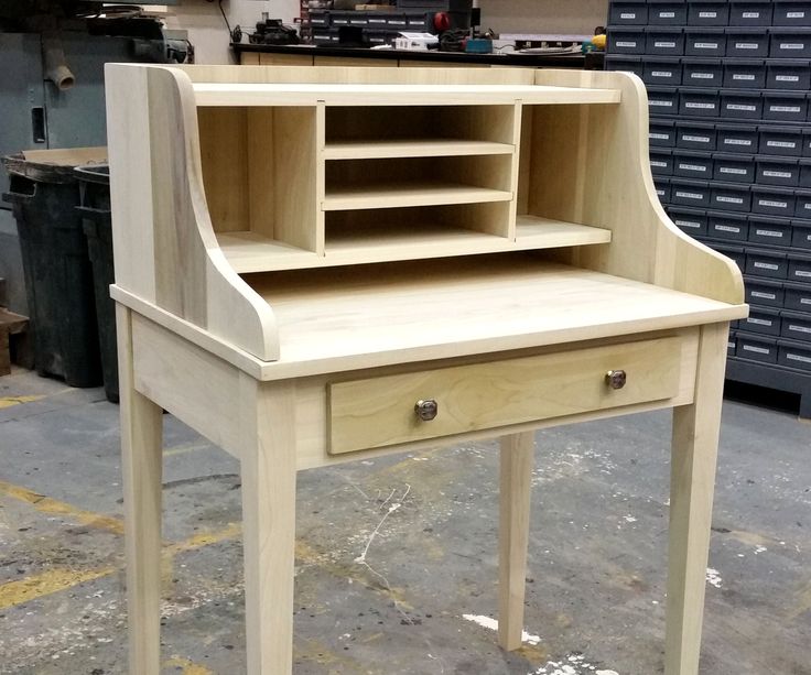 a wooden desk with shelves and drawers on it