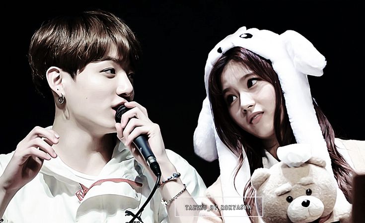 two young people with bunny ears on their heads, one holding a microphone while the other holds a teddy bear