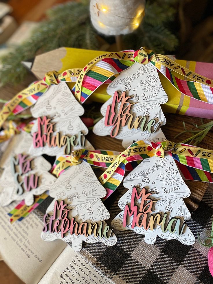 decorated cookies sitting on top of a table next to a christmas ornament and ribbon